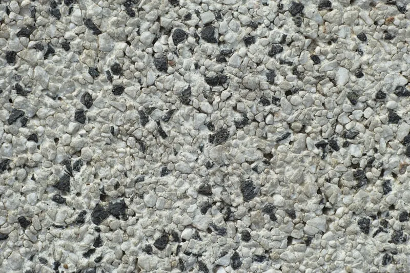 Close-up of exposed aggregate concrete surface showing gravel and cement composition